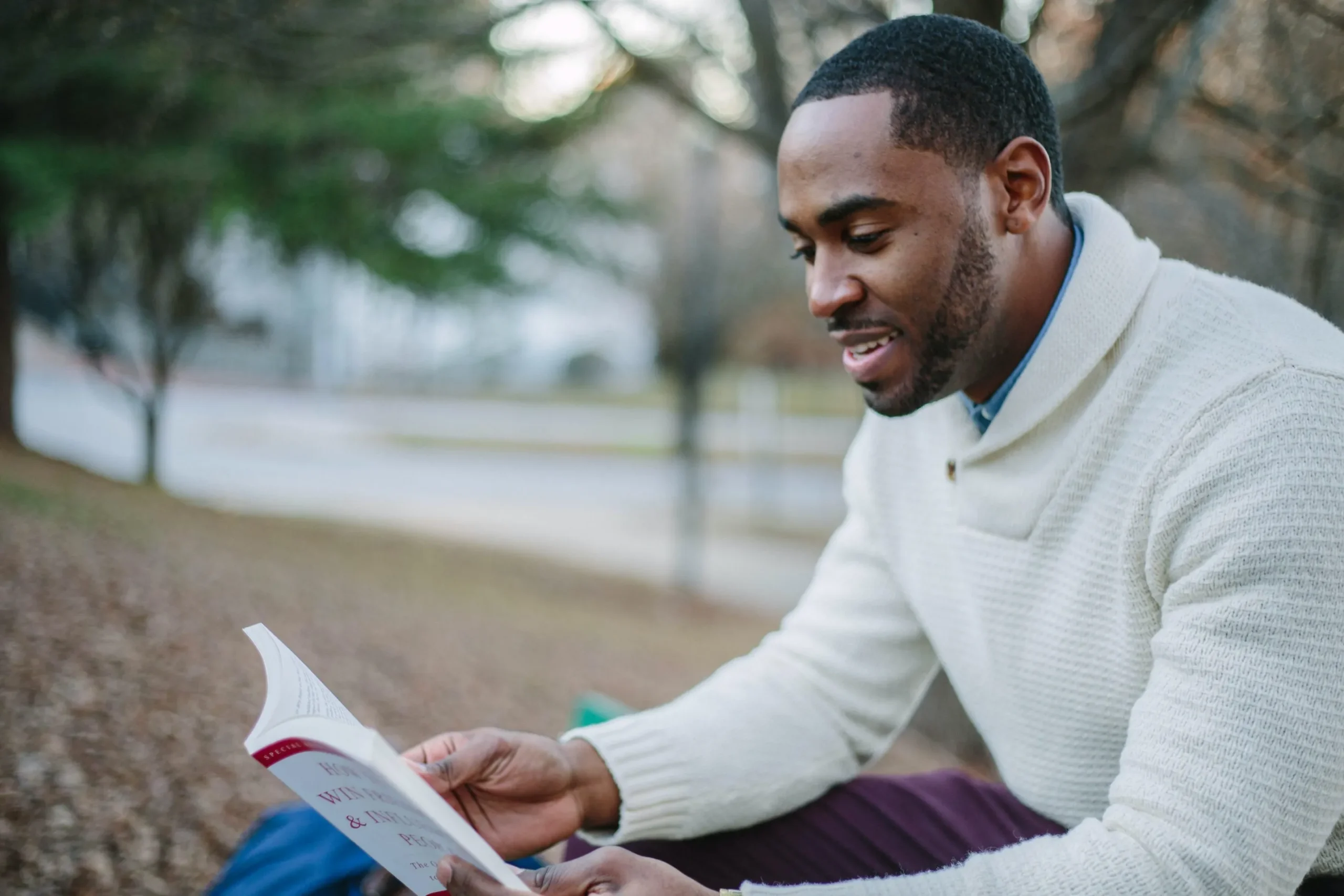 man reading a book outside